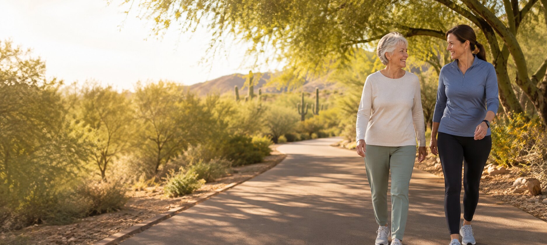 An older adult and wellness companion enjoying a walk together